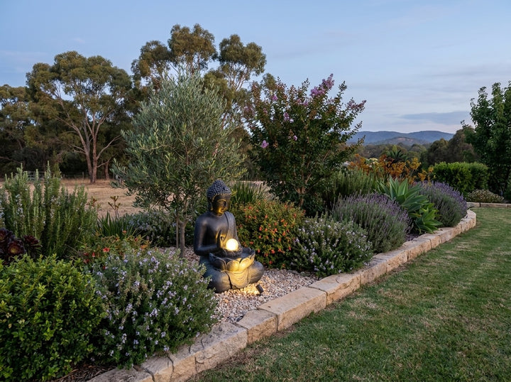 Harmony Medium Water Feature in an established Adelaide Hills garden at dusk, water running and its integrated LED lighting glowing