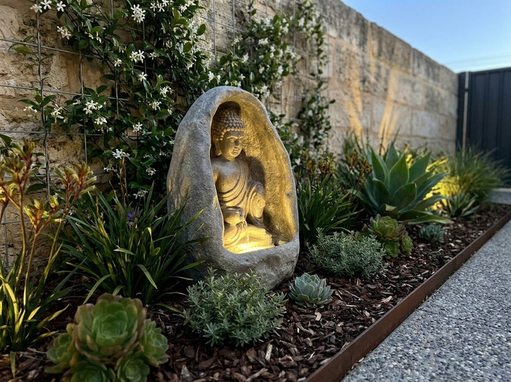 Harmony Small Water Feature in a small city townhouse garden at dusk, water running and its integrated LED lighting glowing
