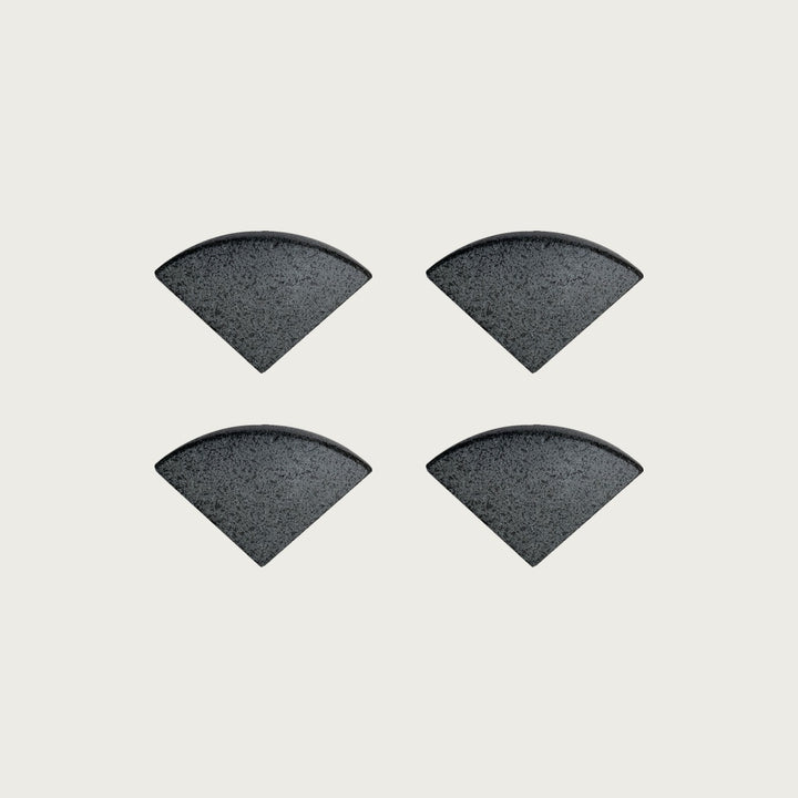 Four Onyx deep near-black terrazzo pot feet — one set of four, for a round or square pot