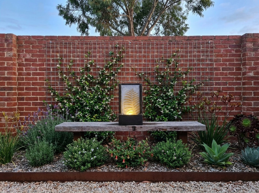 Tranquility Water Feature in a small city townhouse garden at dusk, water running and its integrated LED lighting glowing