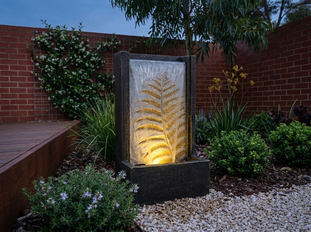 Tranquility Water Feature in a small city townhouse garden at dusk, water running and its integrated LED lighting glowing